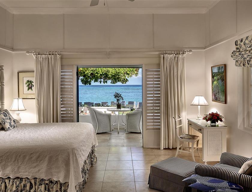 A room with a bed and a table and chairs